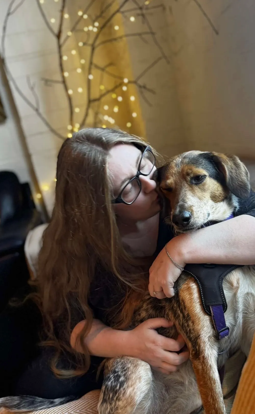 Kiera Knight, company secretary and bookkeeper, hugging Oakleigh the office dog